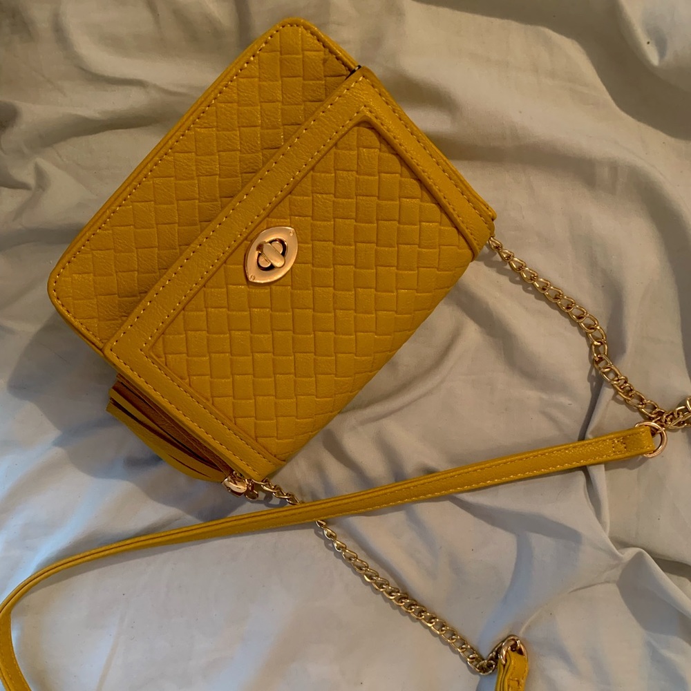 Yellow LG purse w/ yellow tassel. Polka dot lining fabric.